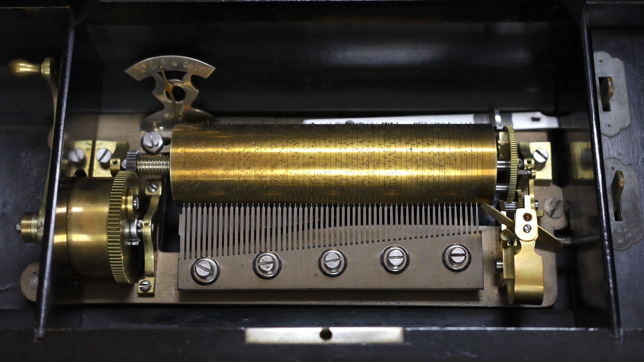 A late 19th century Swiss rosewood and marquetry cased cylinder music box, playing six airs, lacking tune sheet, 43cms wide x 14cms high